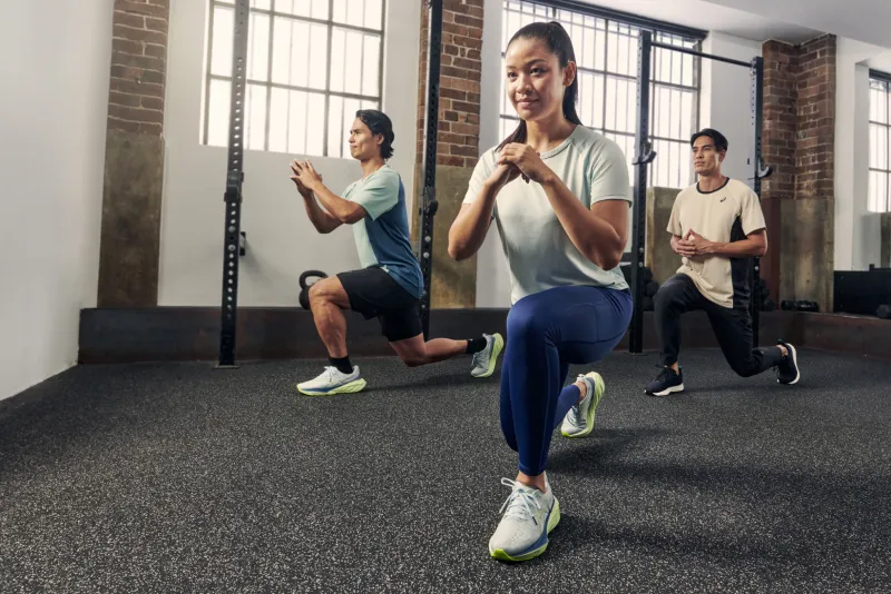 ASICS athletes stretching at the gym doing lunges
