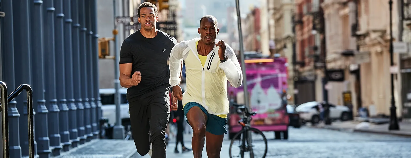Two men running together in the city