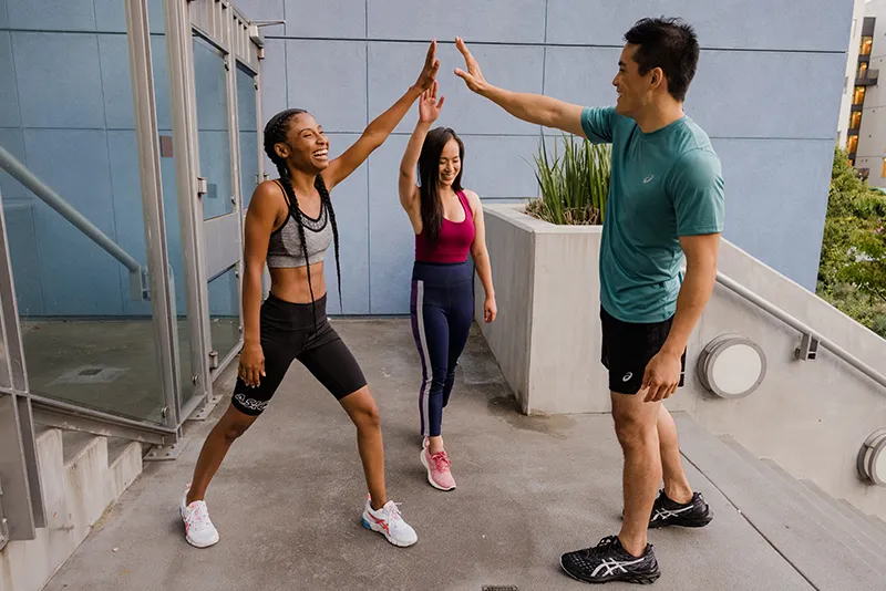 Three runners high-fiving