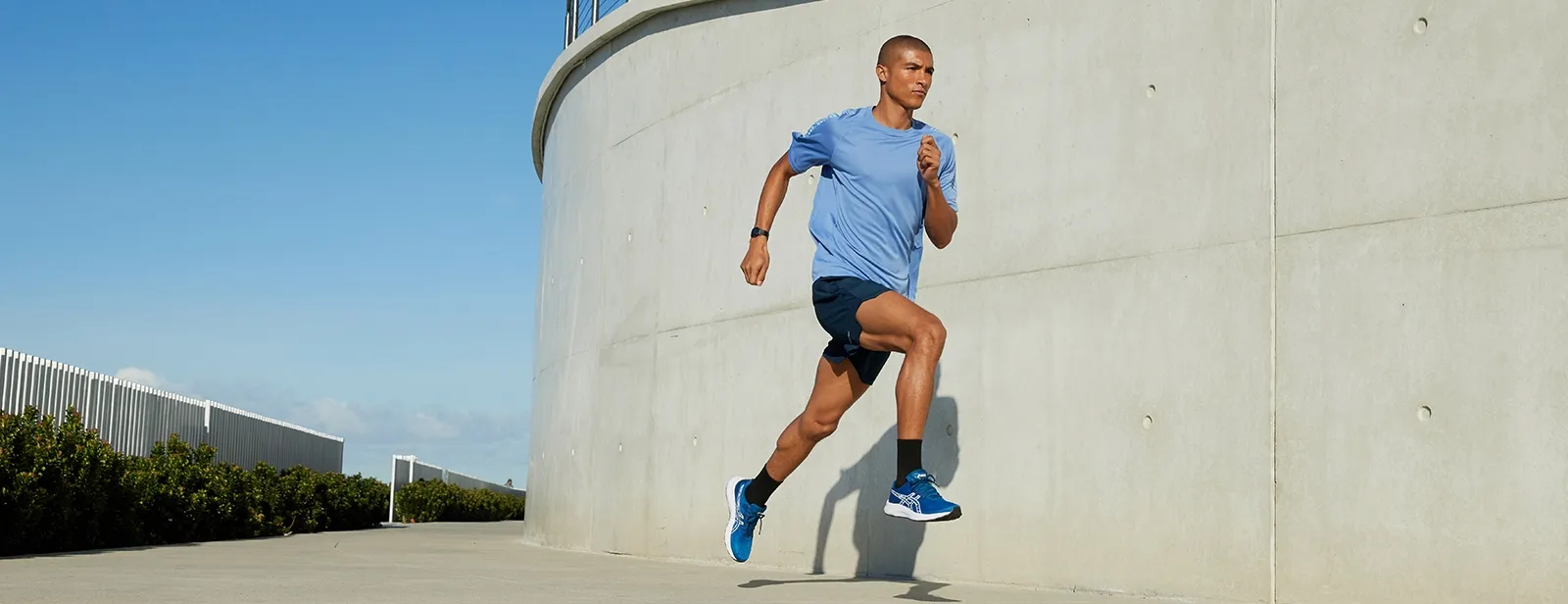 Man running in ASICS running shorts outside
