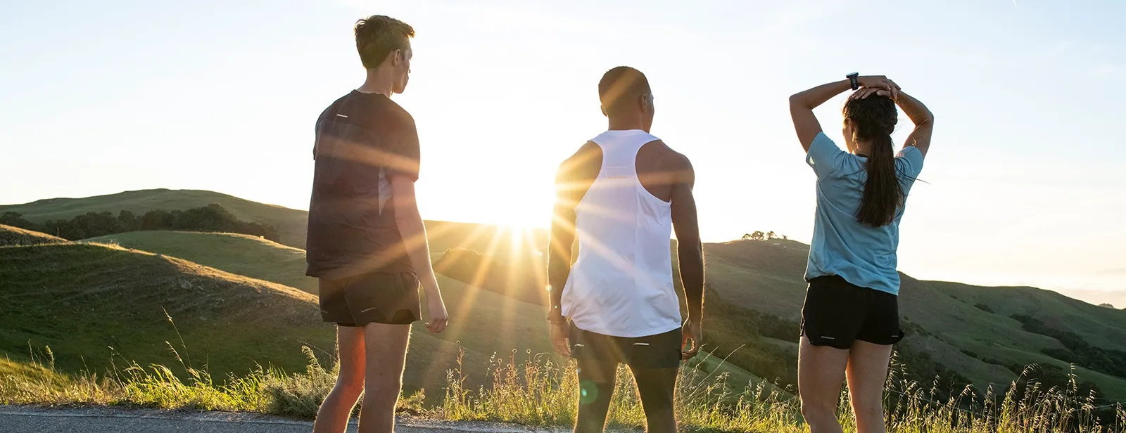 3 runners outdoors during the sunset