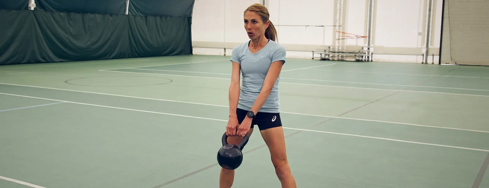 women holding a kettlebell