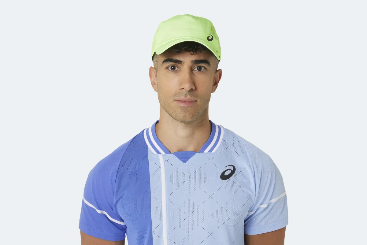 Male model in green ASICS cap