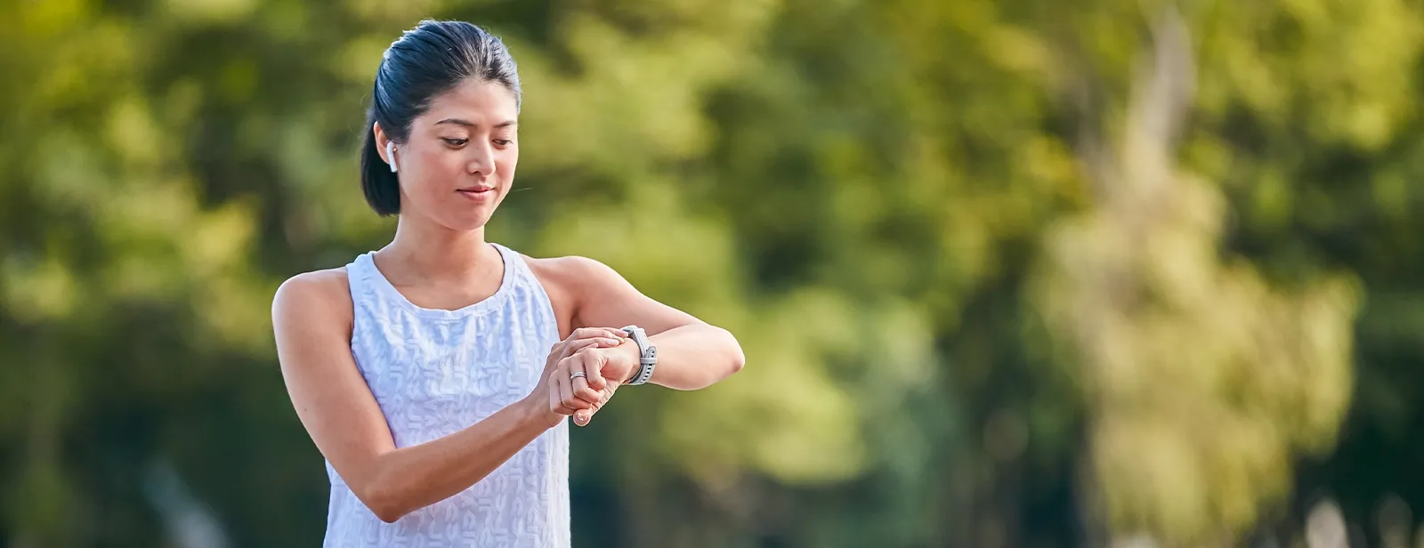 Women looking at watch on wrist outdoors