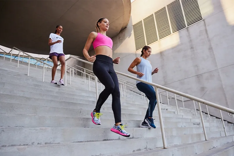 Three people walking down the stairs