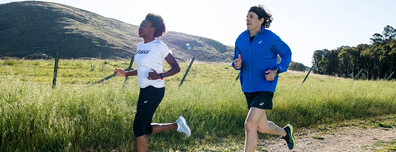 Two runners running in a field