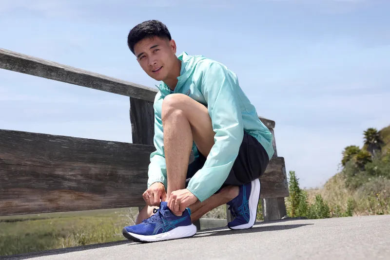 ASICS athlete tying shoes