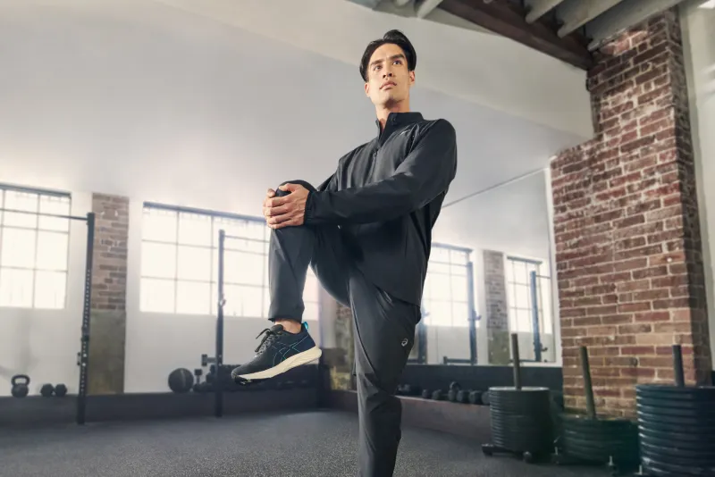 ASICS athlete stretching in the gym