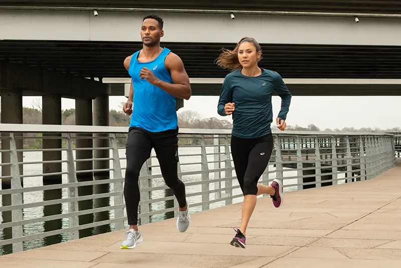man and woman running outdoors