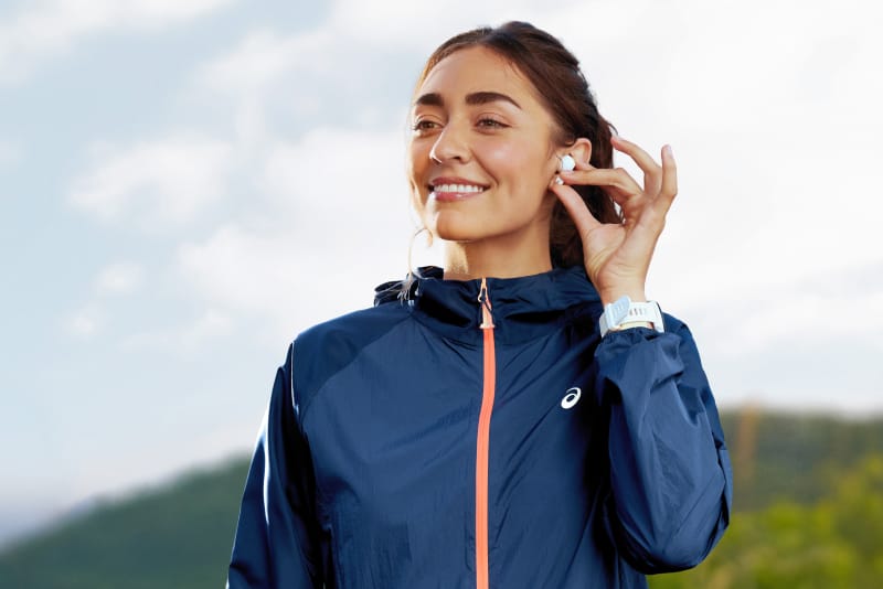ASICS athlete putting in headphones for a workout