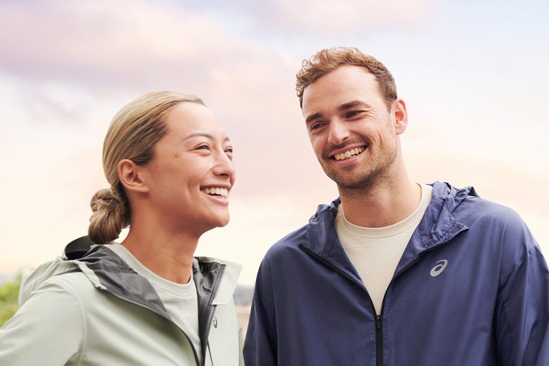 man and woman in the ASICS light weight running jacket 