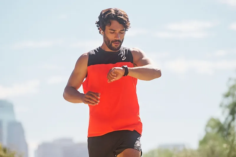 Man running looking at watch