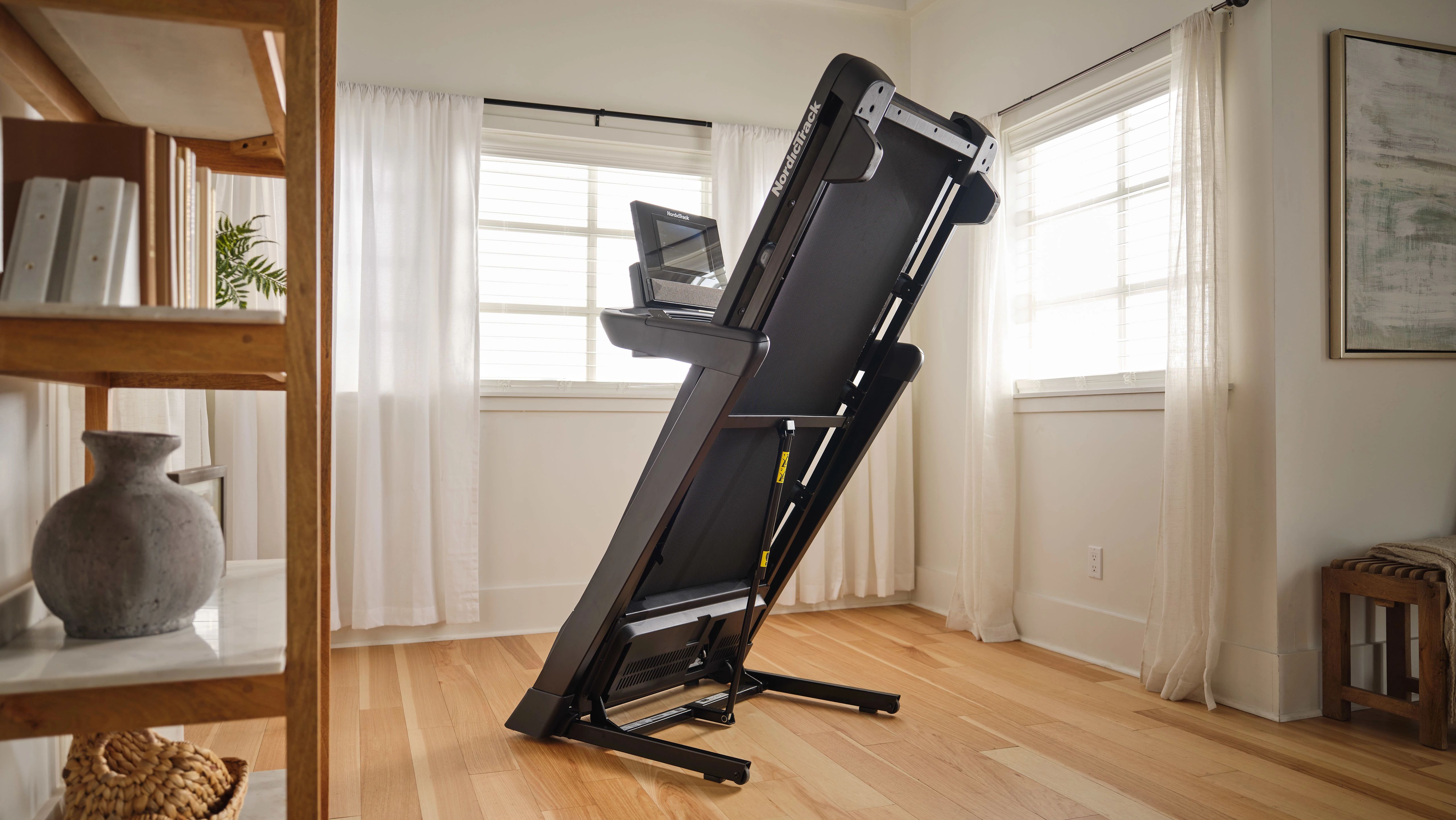 Treadmill set up in a compact home exercise space