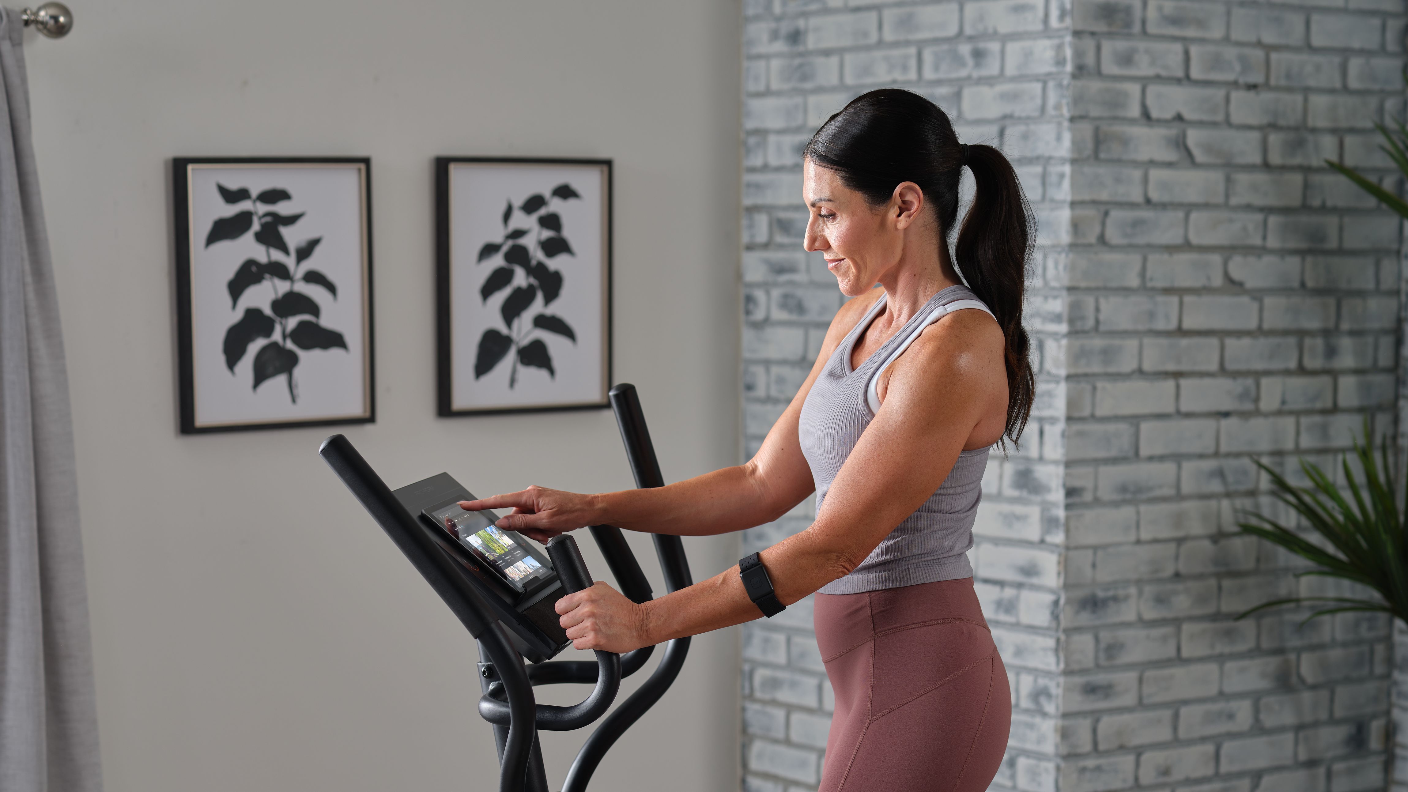 Elliptical machine set up in a compact home exercise space