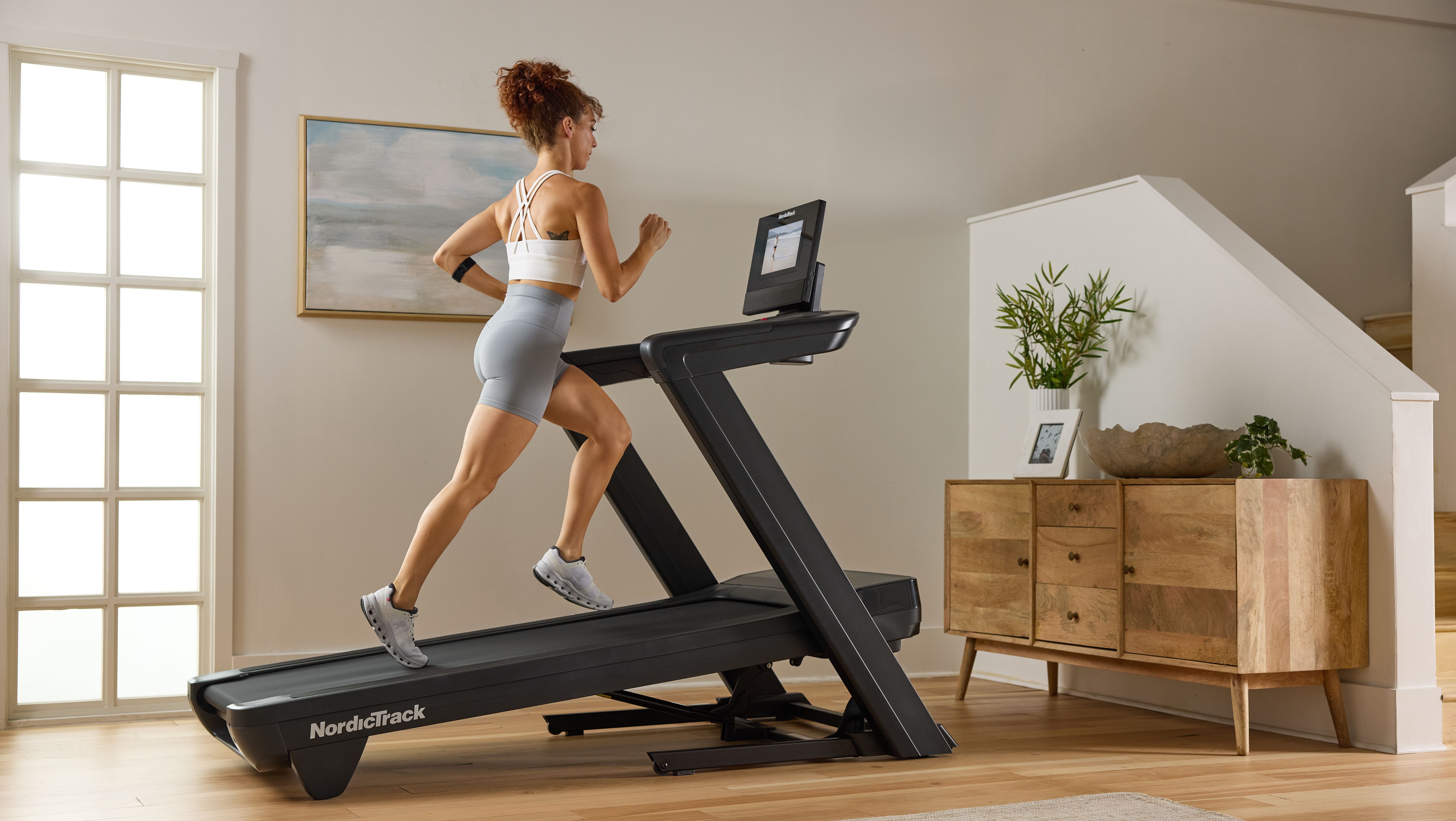Home treadmill in a bright living space with a touchscreen console