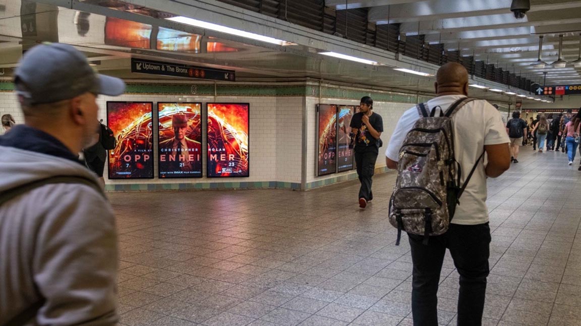 Oppenheimer ad on triptych in subway station