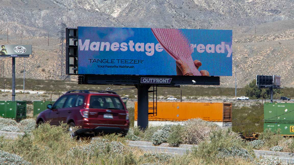 Tangle Teezer digital billboard with Manestage Ready pun copy outside Coachella