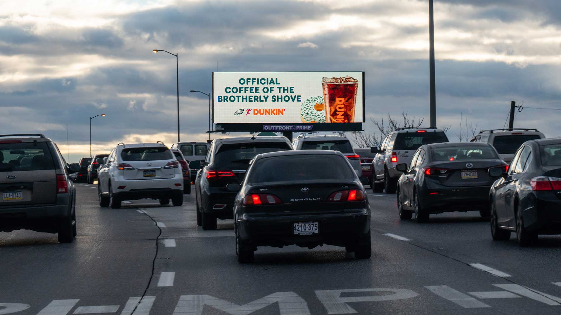 outfront billboard in philadelphia for dunkin featuring contextually relevant eagles creative
