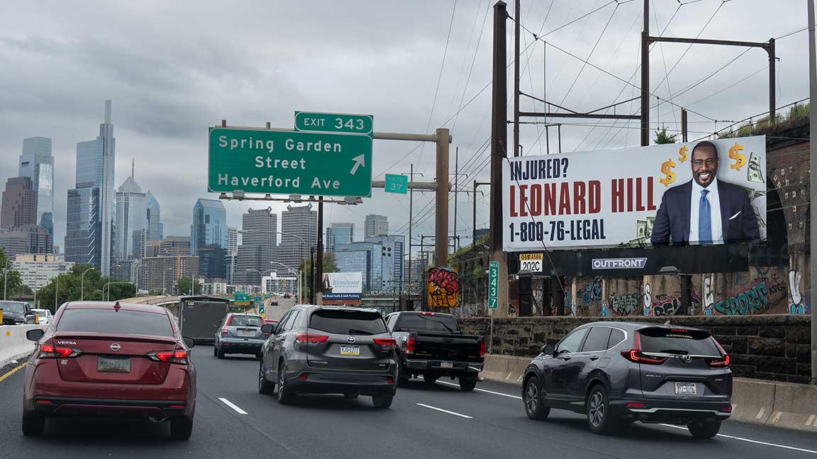outfront billboard in philadelphia for leonard hill & associates next to interstate by center city