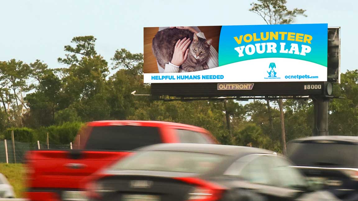 Orange County Animal Shelter billboard that says volunteer your lap