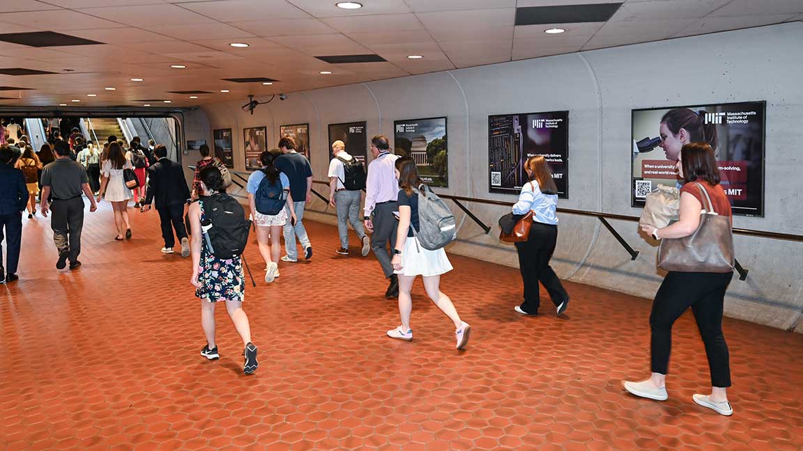 Commuters pass by MIT two-sheet poster transit ads in WMATA Metrorail station