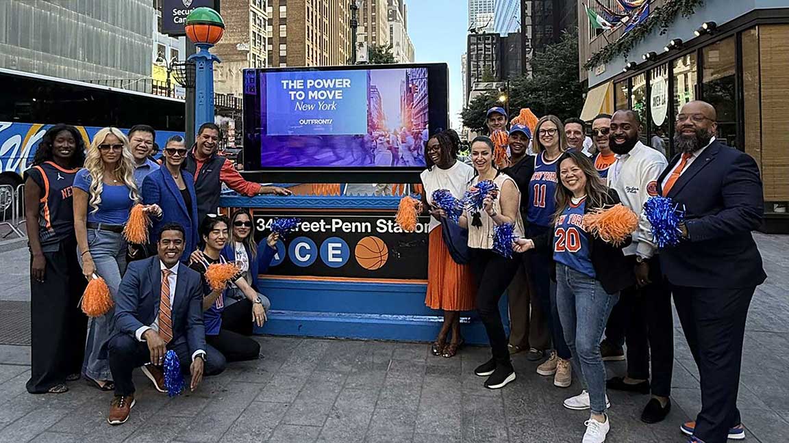 Fans gathered around a NYC Subway entrance painted in Knicks colors