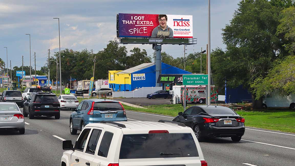 OUTFRONT STUDIOS x NDSS “I Got That Extra” campaign for National Down Syndrome Awareness Week featuring Max Crawford on digital billboard in Tampa