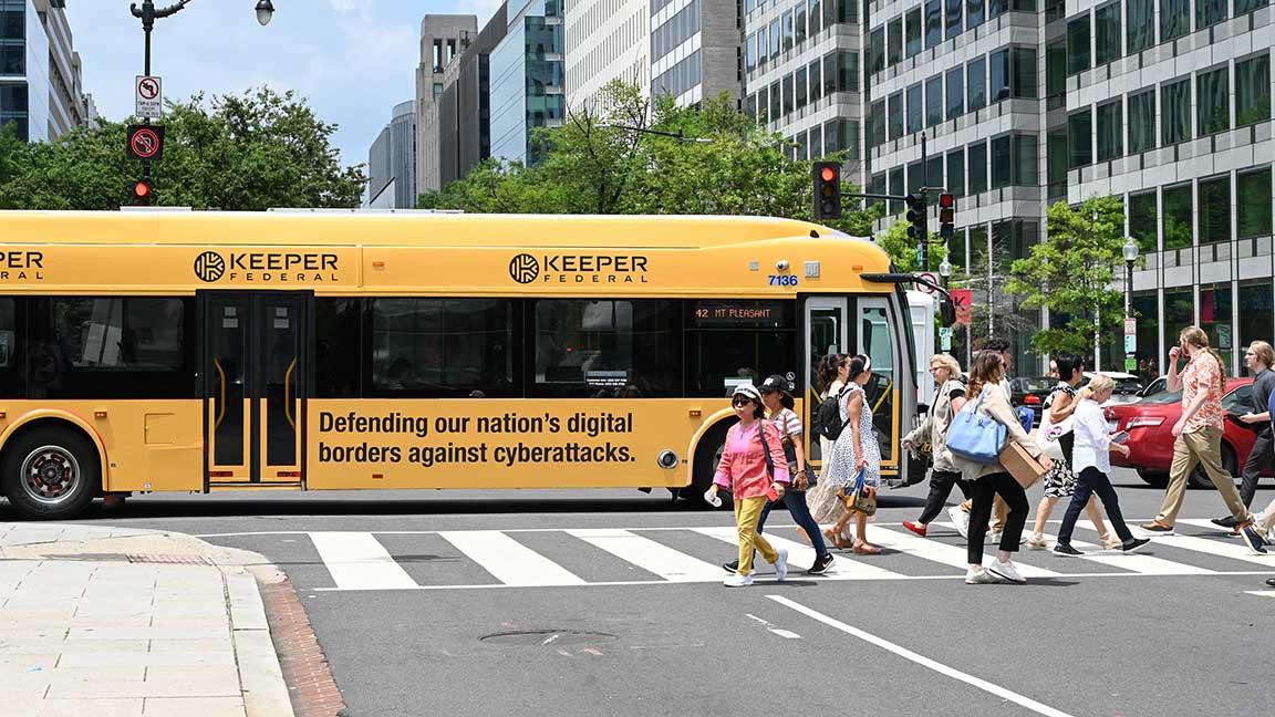Keeper Federal wrap on WMATA DC Metrobus with pedestrians crossing in front