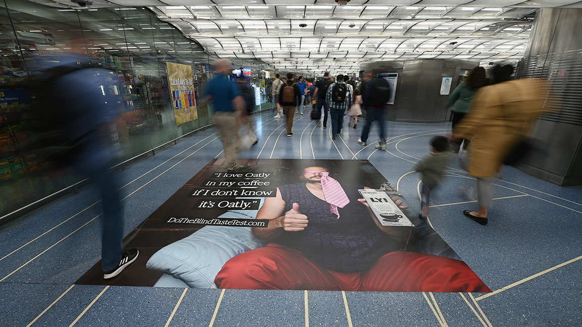Oatly floor ad in Chicago Metra station domination