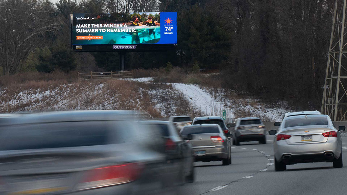 Visit Orlando digital billboard campaign with dynamic temperature data in creative