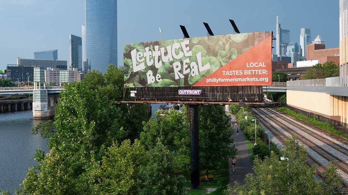 OUTFRONT billboard in Philadelphia for Philly Farmers Market adjacent to river and railroad tracks