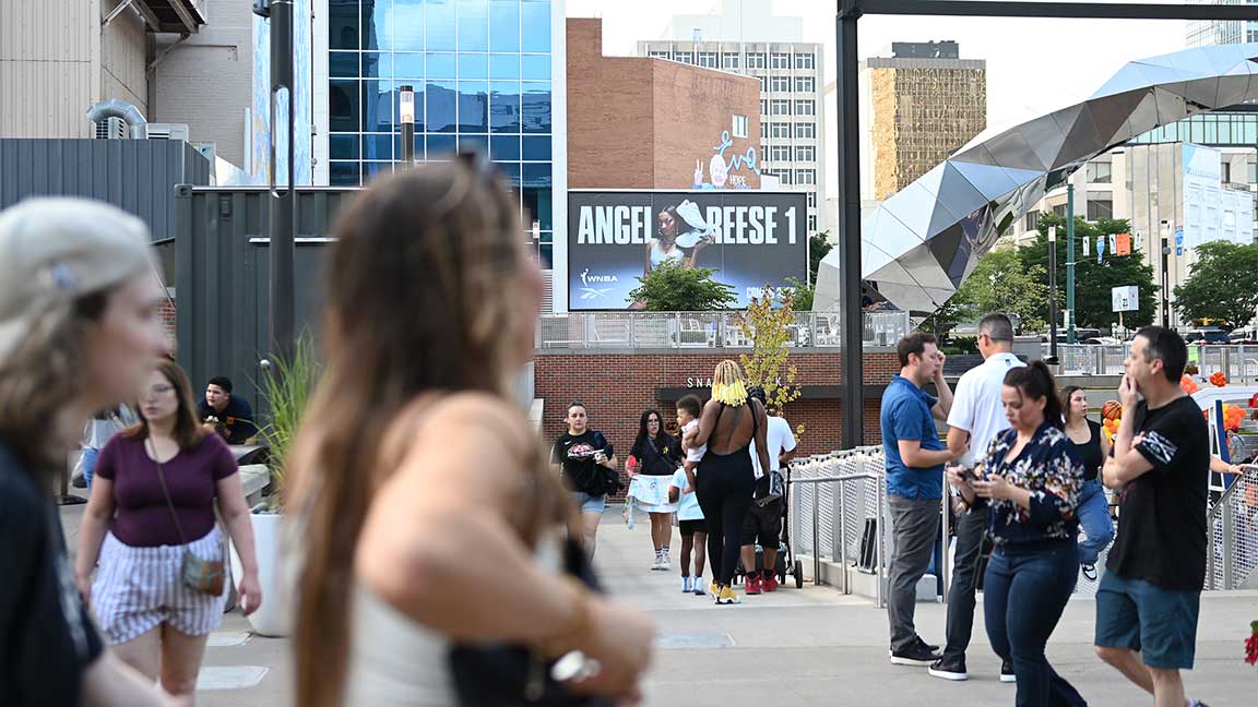 Crowds walking past Angel Reese 1 Reebok wallscape in Indianapolis for WNBA All-Star Weekend