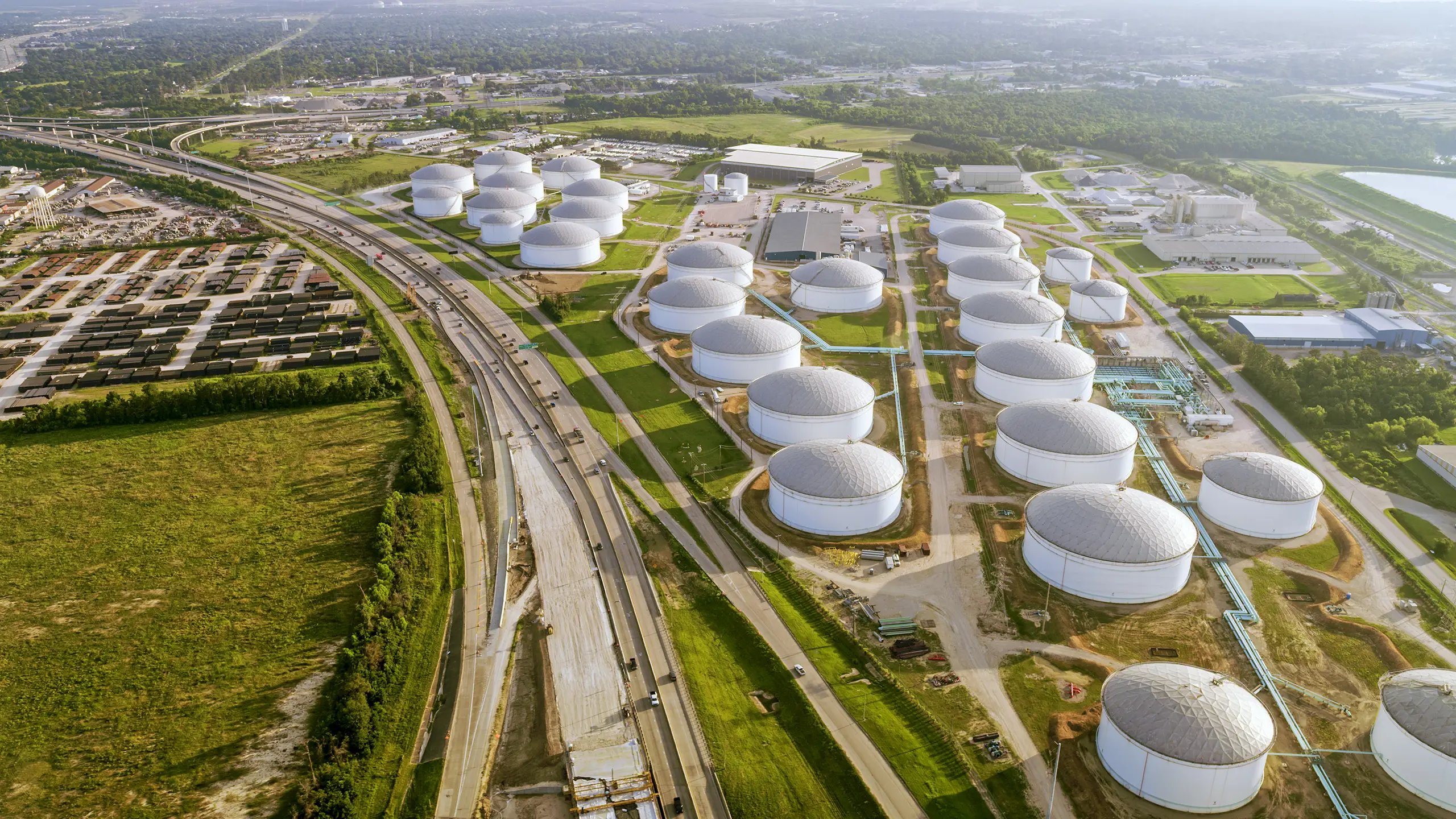 Image showing fuel terminals sitting in a green field and framed by highways.