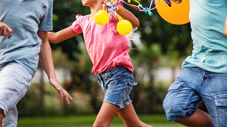 kids enjoying the summer camp and running with balloons