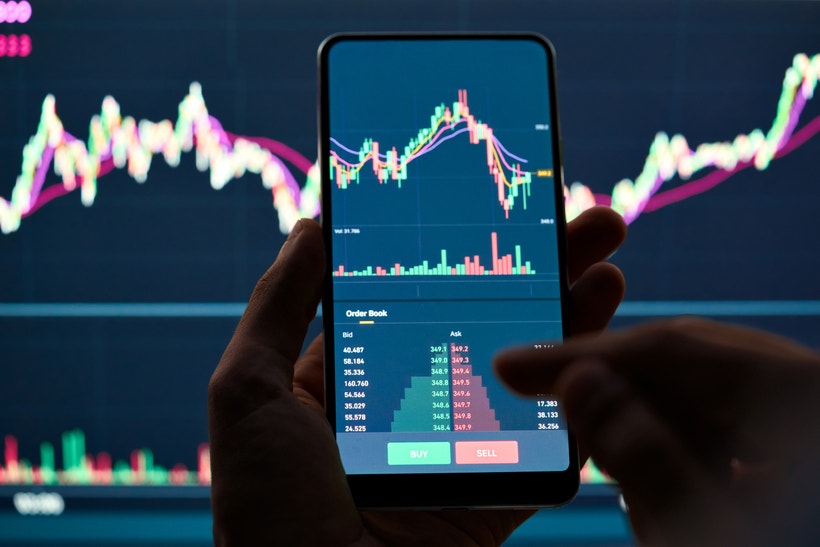 forex chart with phone in front