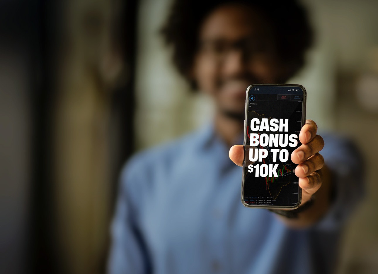 Man holding phone displaying cash bonus up to $10k