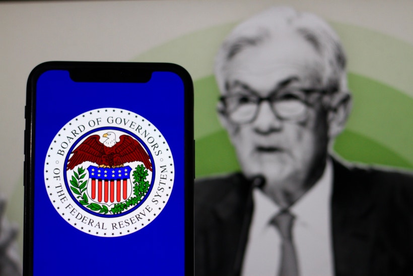 Jerome Powell behind a phone