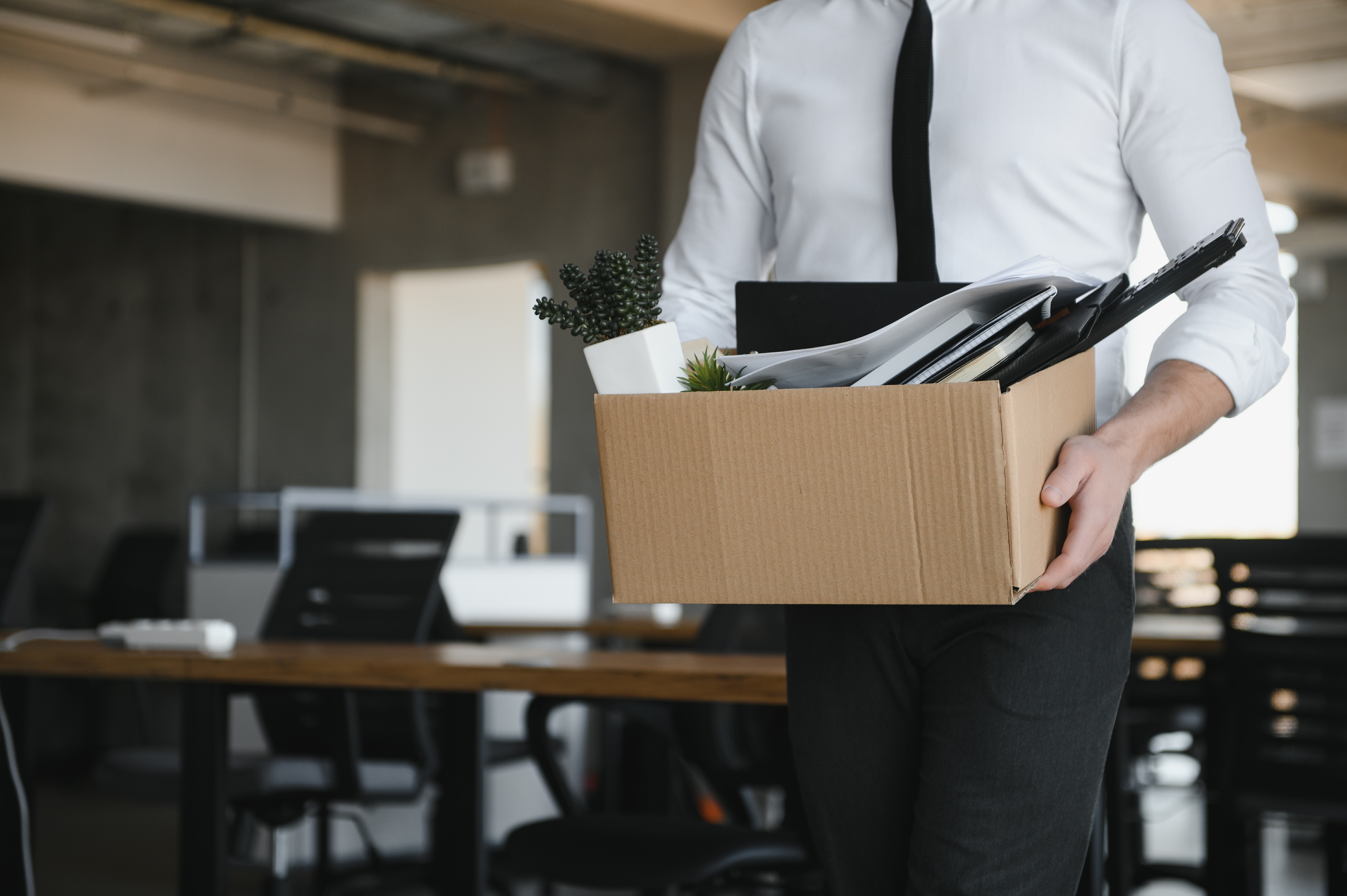 man carrying box in office