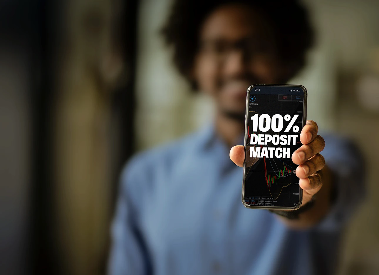Man holding phone displaying cash bonus up to $10k