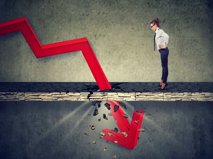woman in business attire staring at a red price line going through the floor