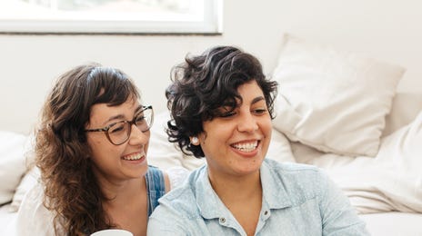 Two women in front of a laptop during a private language class