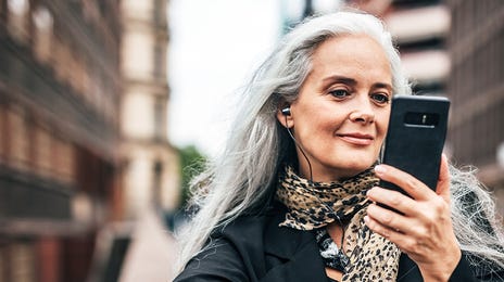 Woman learning a language on her phone with Berlitz Flex