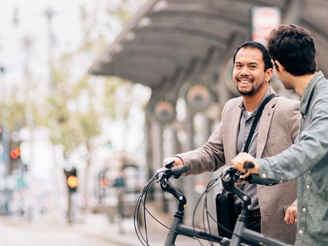 Students pushing their bicycles and chatting after their English class for beginners with Berlitz Algeria