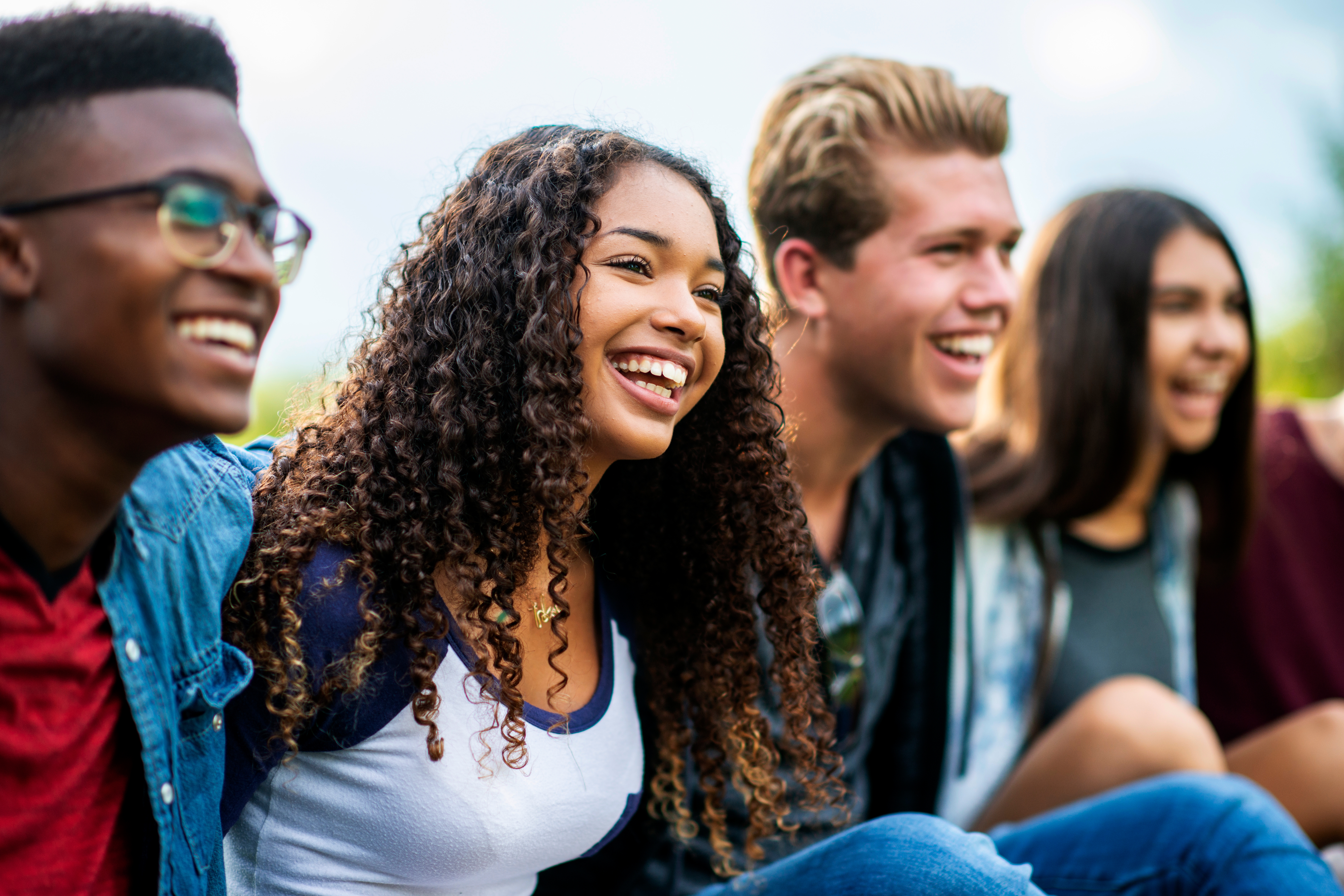 Group of teenagers talking and laughing together after their French class with Berlitz