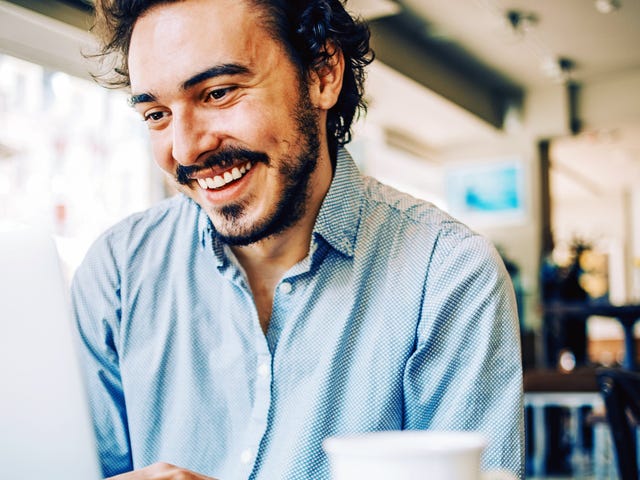 Man taking a self-study course from his laptop in a coffee shop
