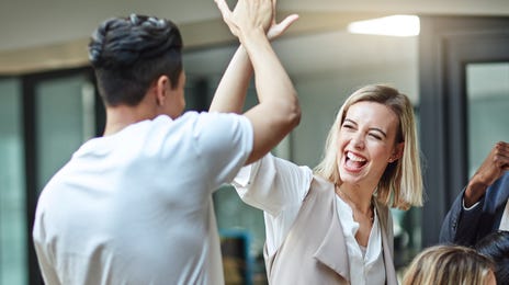 Students high-fiving each other during a language class for groups
