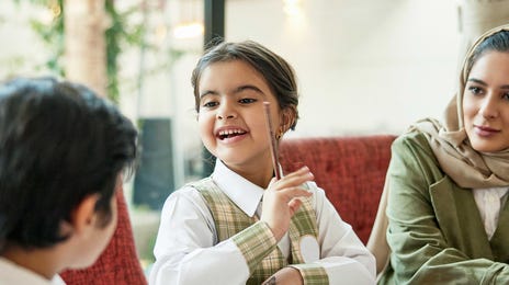 Kids talking to each other in French during a French class with their Berlitz instructor