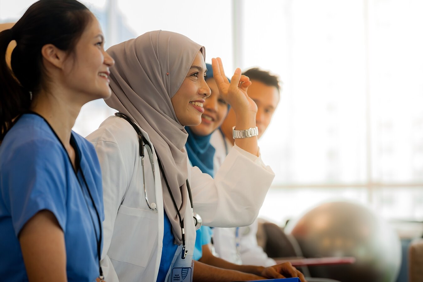 Woman raising her hand during an intermediate French class with Berlitz Algeria