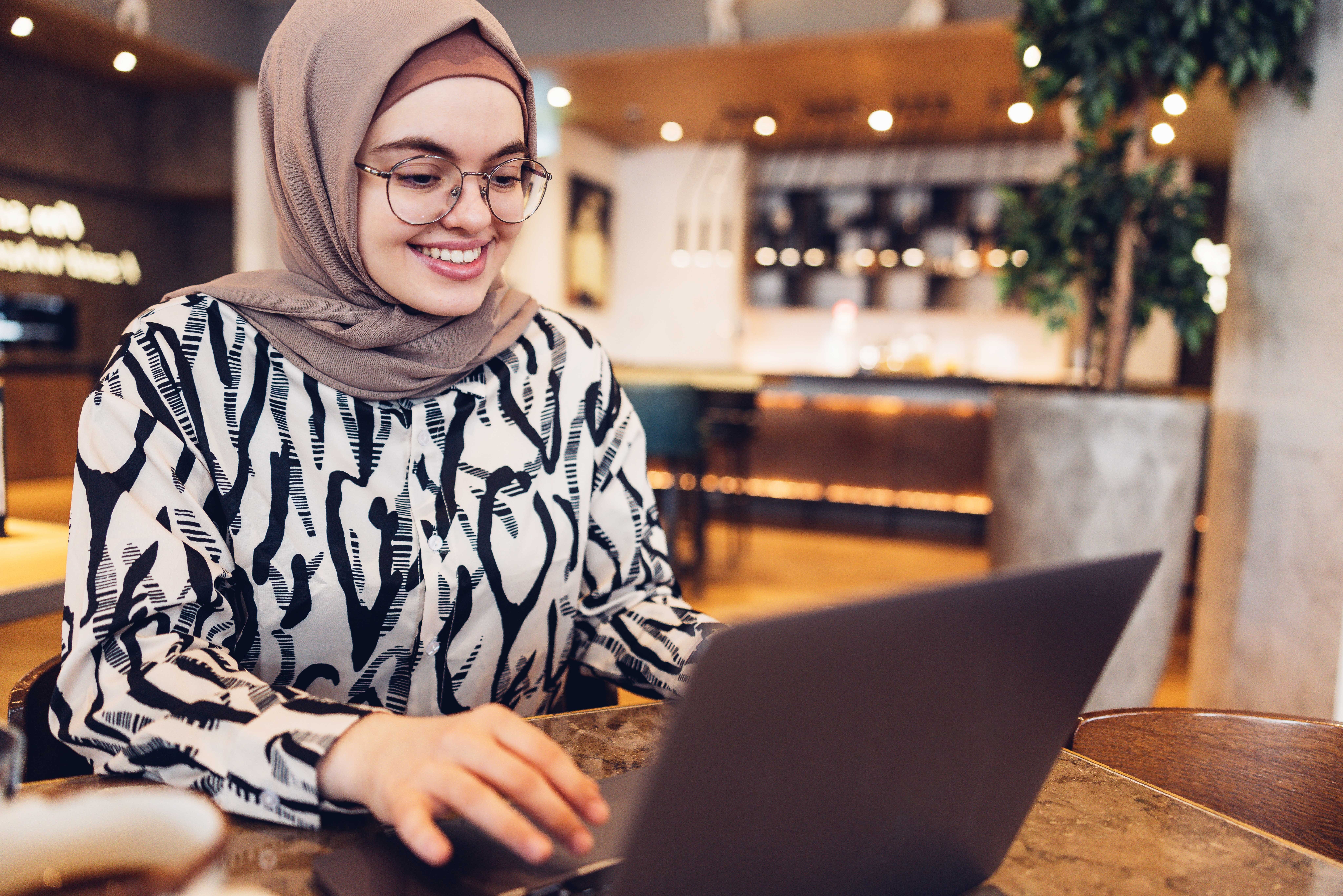Woman attending an intermediate English class from her laptop