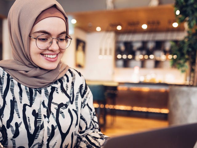 Woman attending an intermediate English class from her laptop